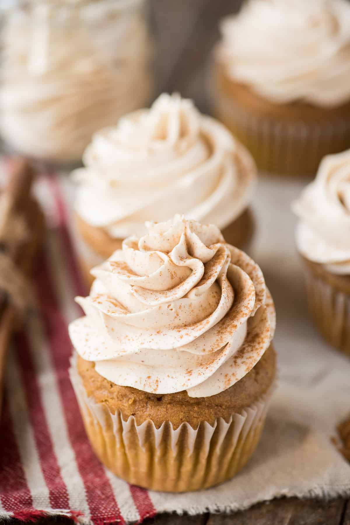 spiced buttercream piped on top of a pumpkin cupcake