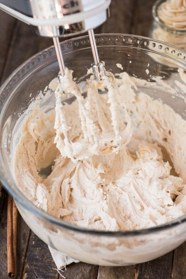 Spiced buttercream is the perfect frosting to pair with pumpkin, chocolate or vanilla cake! With cinnamon and nutmeg, is this a great fall spice frosting! spiced buttercream in mixing bowl with electric mixer
