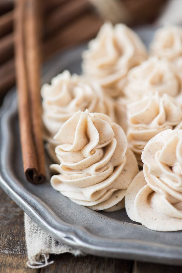 Spiced buttercream is the perfect frosting to pair with pumpkin, chocolate or vanilla cake! With cinnamon and nutmeg, is this a great fall spice frosting! spiced buttercream piped in swirls onto a metal plate