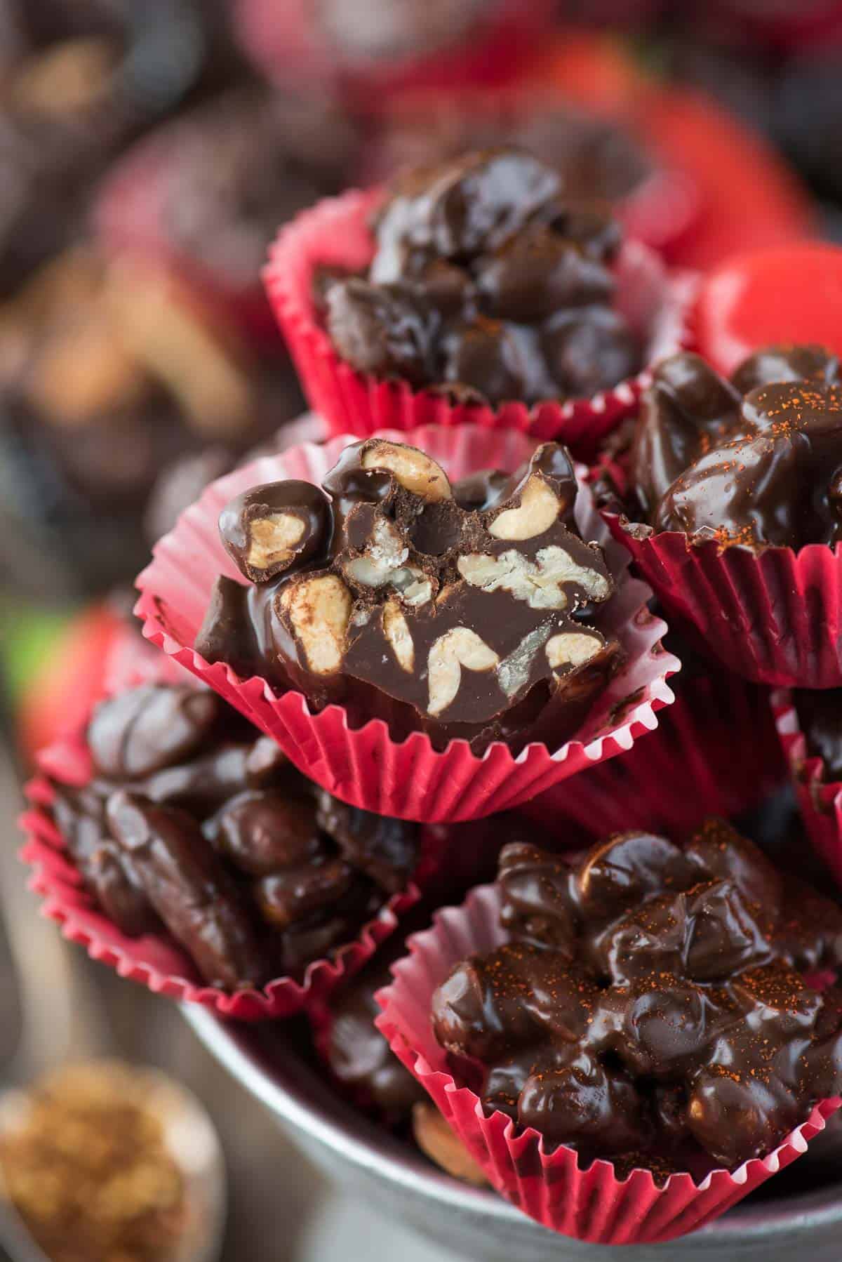 dark chocolate cayenne nut clusters in red mini muffin paper cups