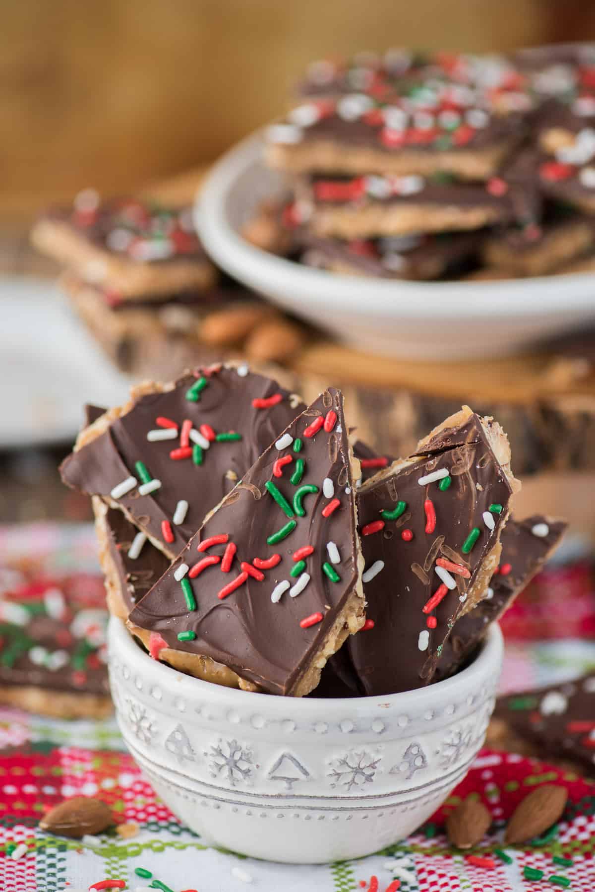english toffee with christmas sprinkles stacked in a white bowl