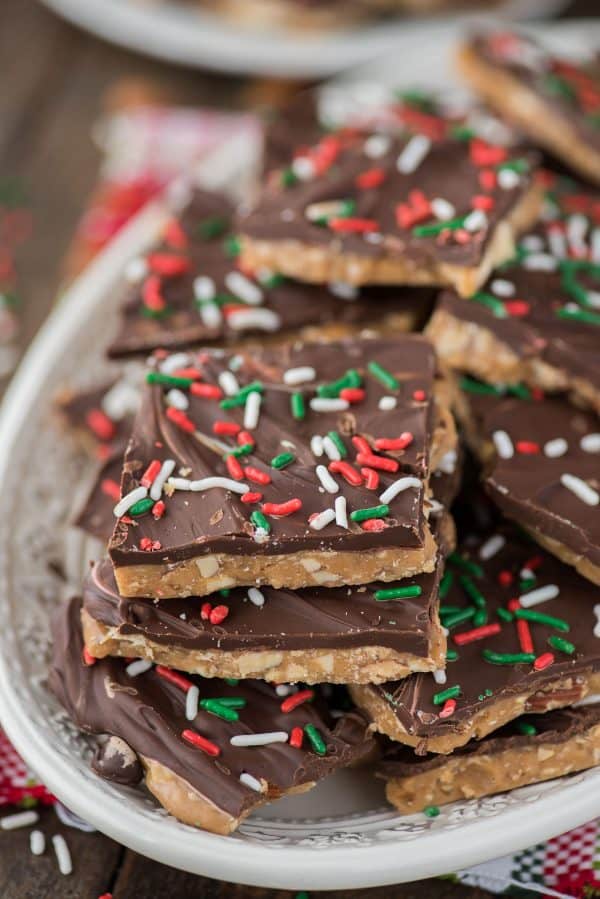How to make homemade english toffee including directions with and without a candy thermometer. This is the MEGA post on toffee! So many tips, everything you’ve wanted to know about making Christmas toffee at home! english toffee with christmas sprinkles stacked on a white plate