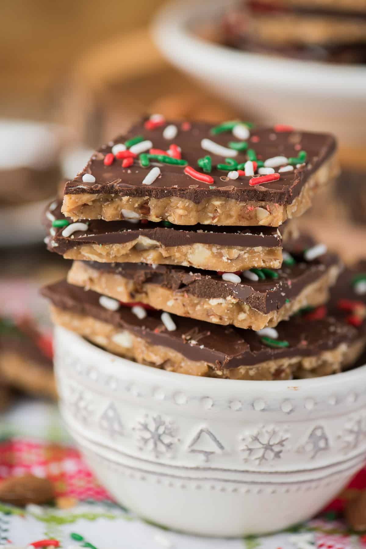 english toffee with christmas sprinkles stacked in a white bowl