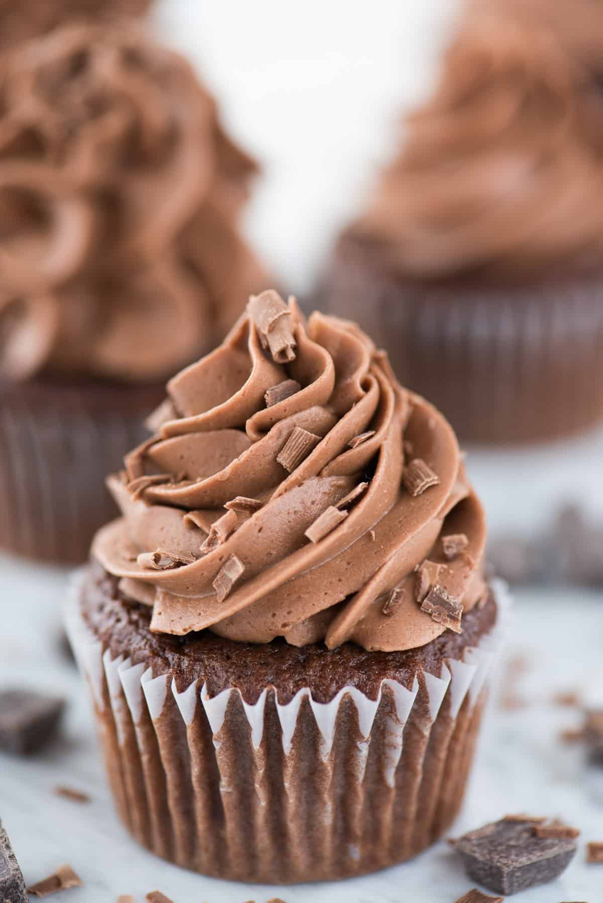 chocolate cupcake with chocolate frosting on white background