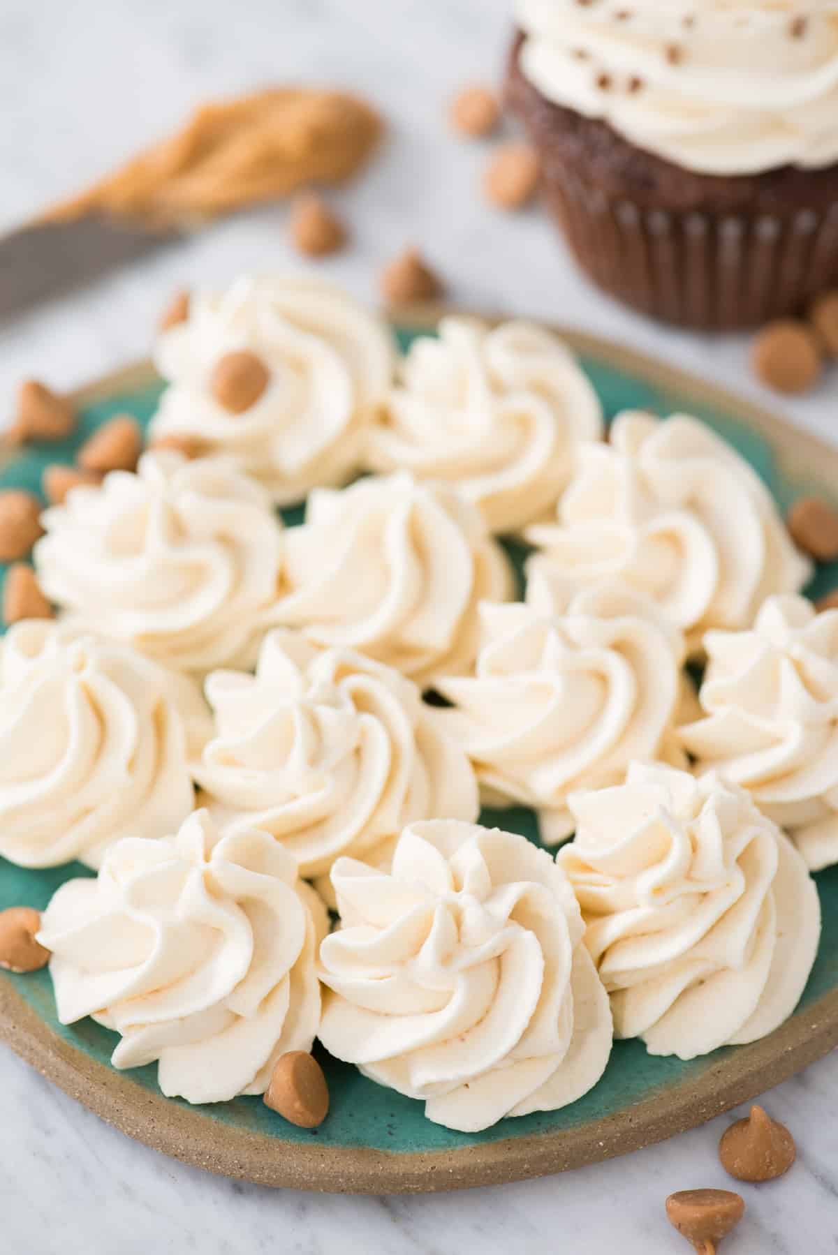 Peanut butter whipped cream piped into swirls on plate