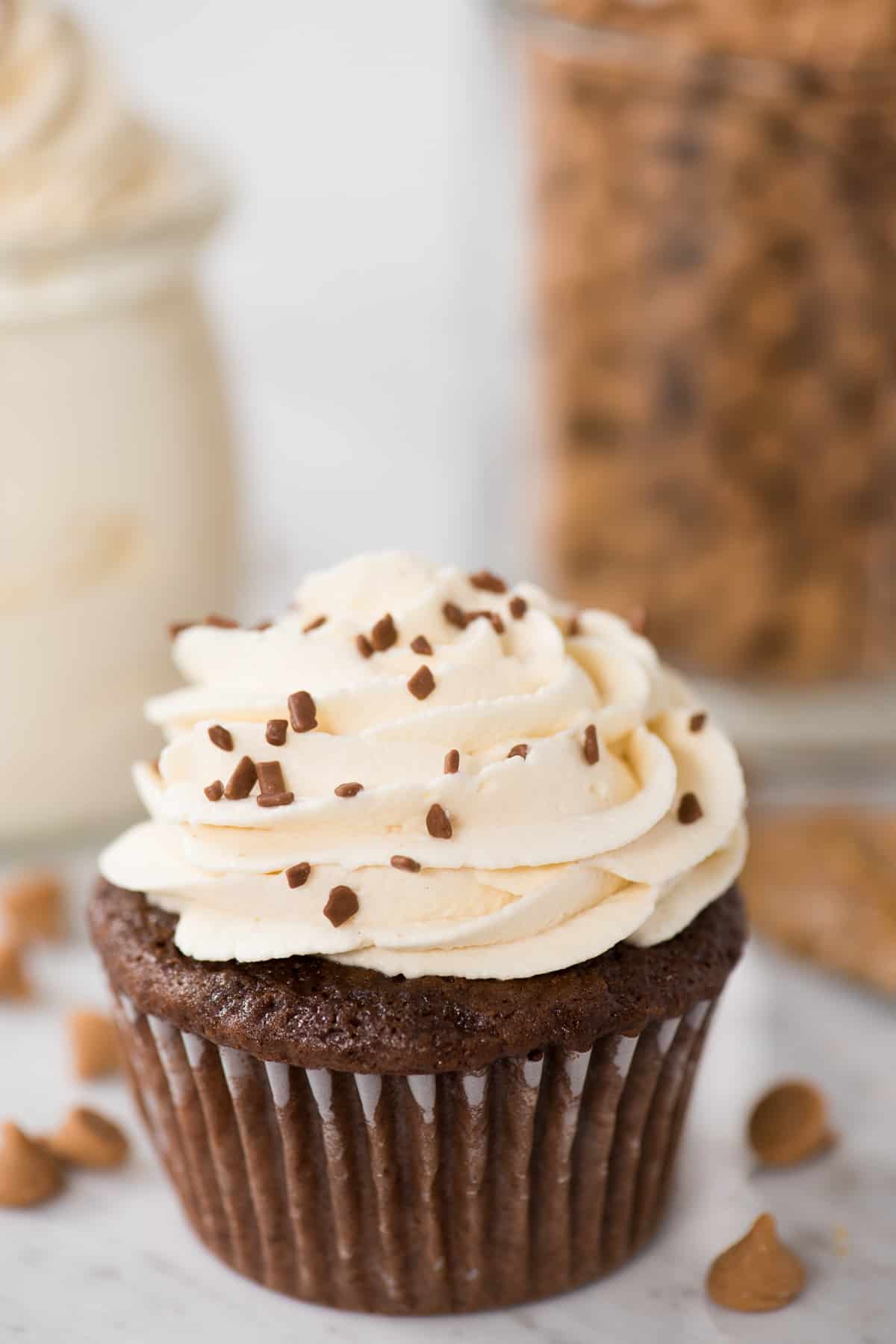 peanut butter whipped cream on top of chocolate cupcake