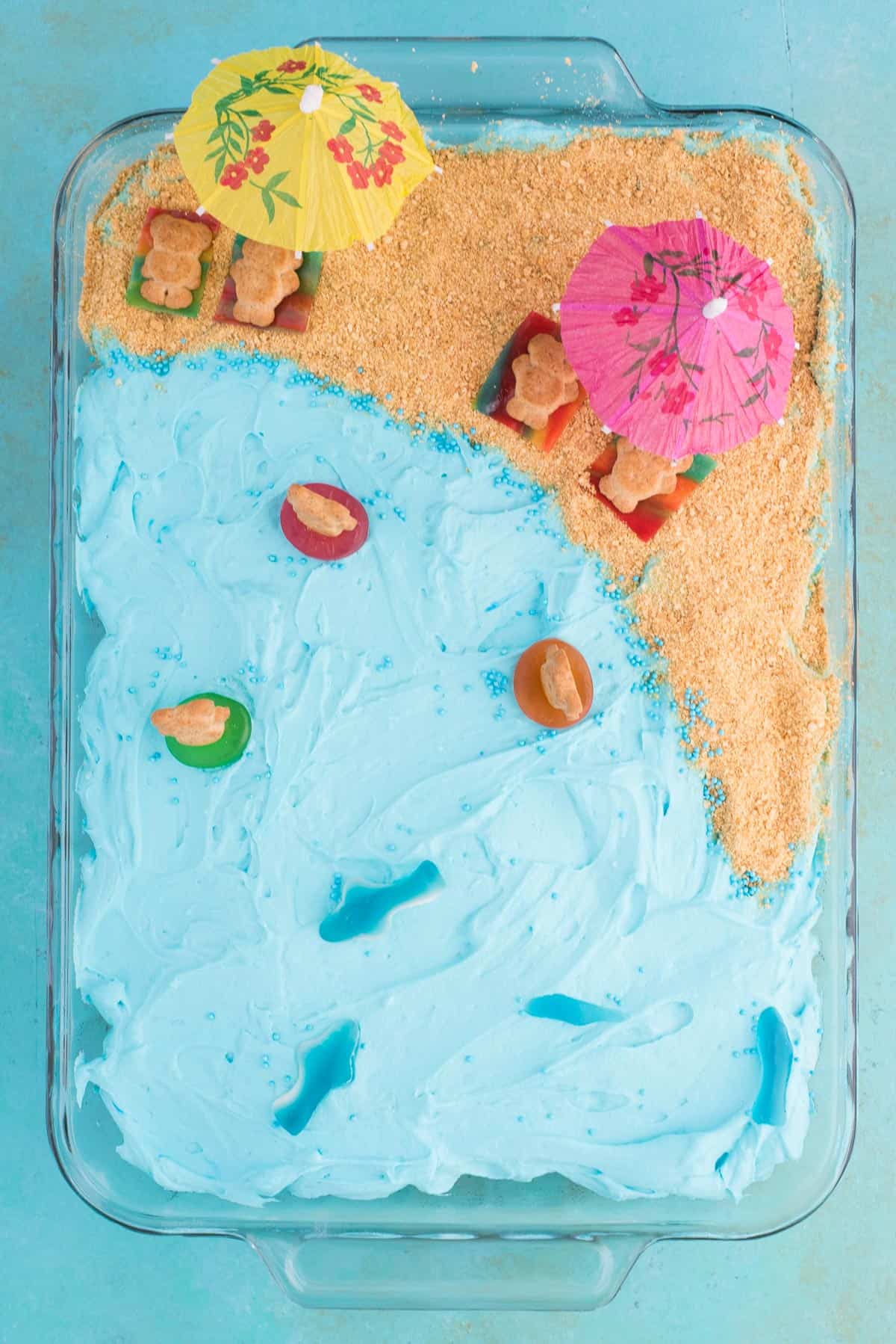Aerial photograph of beach theme cake on blue background
