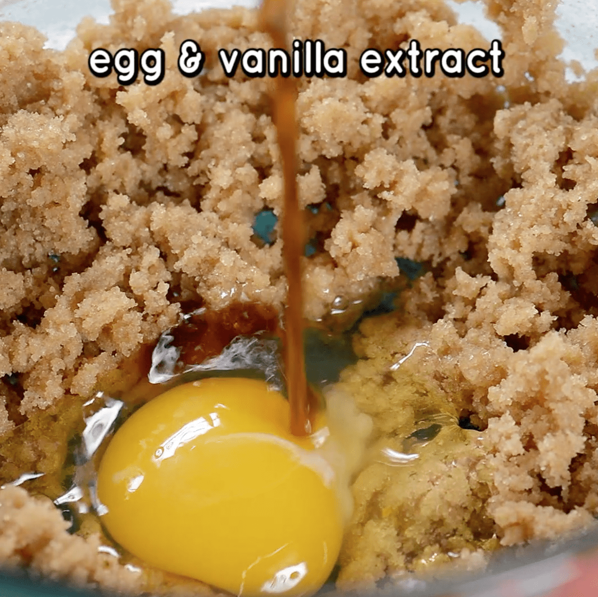 egg and vanilla extract being added to cookie dough