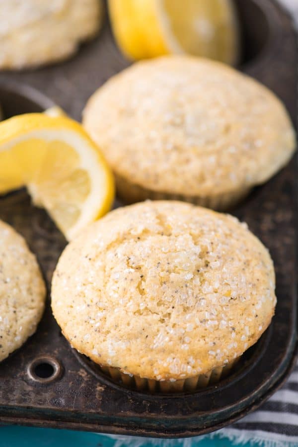 This is my favorite recipe for making bakery style lemon poppy seed muffins! Add course sugar to the tops or drizzle them with lemon glaze. These lemon muffins turn out so moist and flavorful with buttermilk and fresh lemons! Plus good tips on how to bake bakery style muffins! #lemonpoppyseedmuffins #muffins #lemonmuffins lemon poppy seed muffin in metal muffin pan