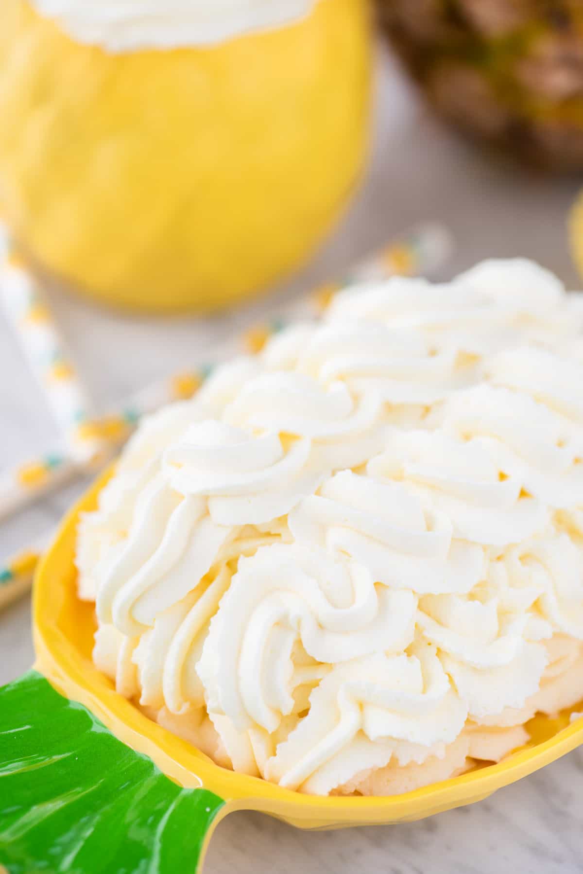 pineapple whipped cream piped onto pineapple plate