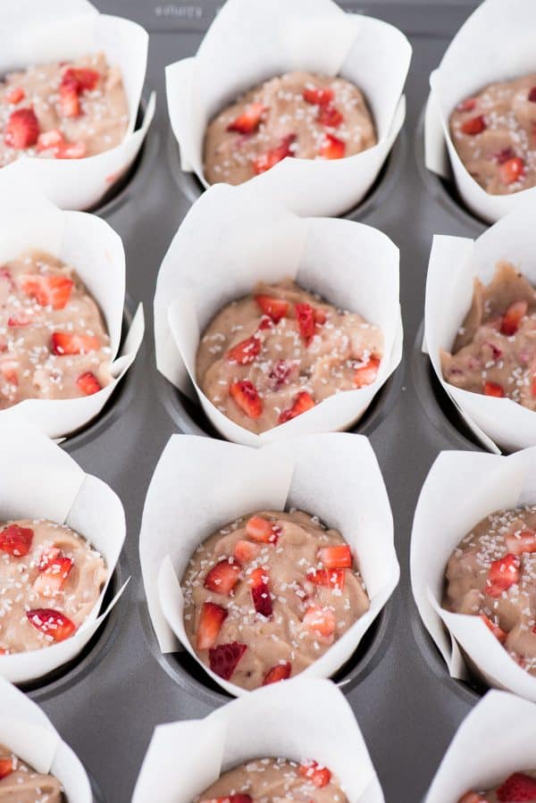 Use those ripe bananas and make fresh strawberry banana muffins. These strawberry muffins are dairy free and have been tested with gluten free flour with AMAZING results! You can also use frozen bananas and frozen strawberries to make these muffins. strawberry banana muffins in white parchment paper liners in muffin pan