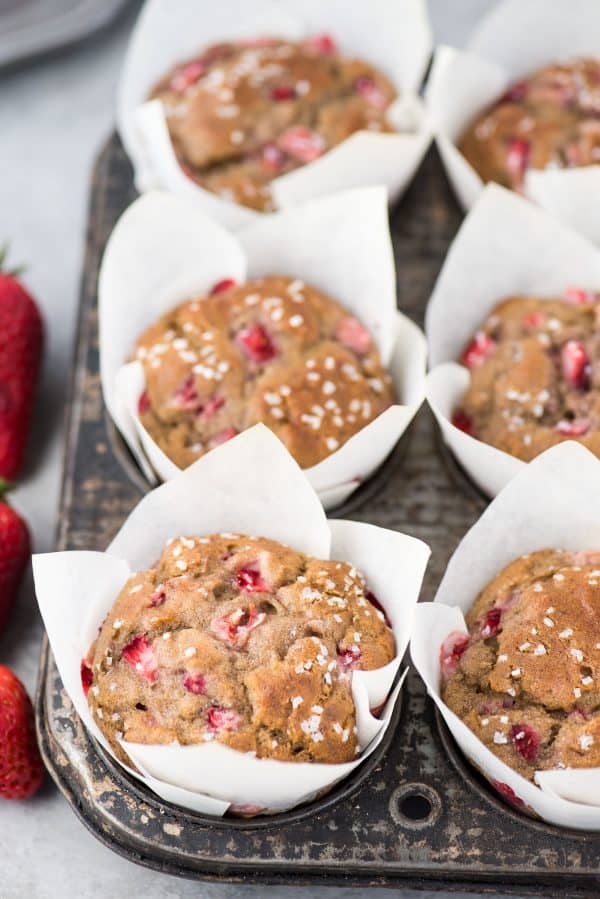 Use those ripe bananas and make fresh strawberry banana muffins. These strawberry muffins are dairy free and have been tested with gluten free flour with AMAZING results! You can also use frozen bananas and frozen strawberries to make these muffins. strawberry banana muffins in white parchment paper liners in metal muffin tin