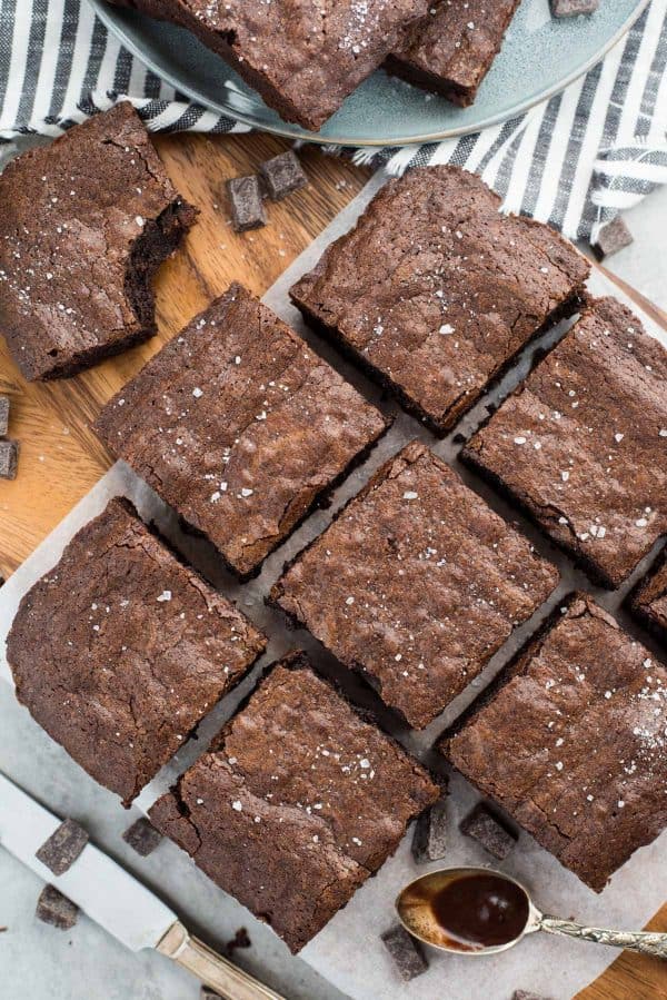 homemade brownies cut into squares on a wooden platter
