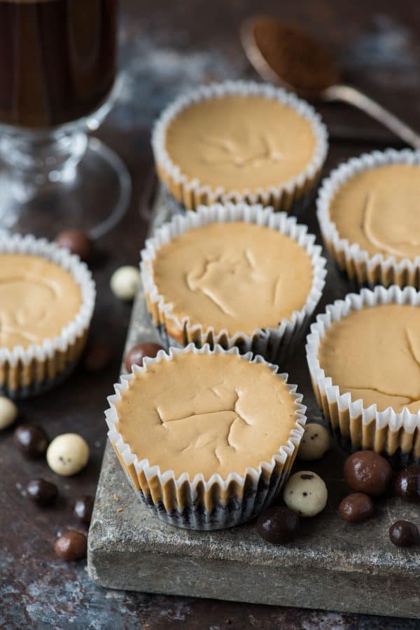 This is a crowd favorite mini coffee cheesecake recipe that you’ll use over and over! The whole recipe is only 7 ingredients and you make it in a regular size muffin pan! Plus, you can do an oreo crust or graham cracker crust for these mini espresso cheesecakes. #minicheesecake #coffeecheesecake #minicoffeecheesecake #espressocheesecake #mochacheesecake mini coffee cheesecakes on stone slab with espresso beans