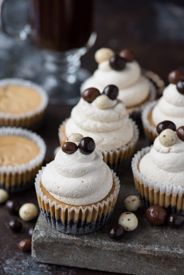This is a crowd favorite mini coffee cheesecake recipe that you’ll use over and over! The whole recipe is only 7 ingredients and you make it in a regular size muffin pan! Plus, you can do an oreo crust or graham cracker crust for these mini espresso cheesecakes. #minicheesecake #coffeecheesecake #minicoffeecheesecake #espressocheesecake #mochacheesecake mini coffee cheesecake on stone slab with whipped cream and espresso beans
