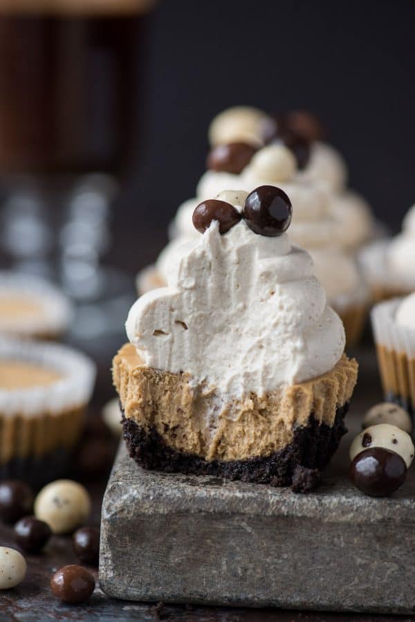 This is a crowd favorite mini coffee cheesecake recipe that you’ll use over and over! The whole recipe is only 7 ingredients and you make it in a regular size muffin pan! Plus, you can do an oreo crust or graham cracker crust for these mini espresso cheesecakes. #minicheesecake #coffeecheesecake #minicoffeecheesecake #espressocheesecake #mochacheesecake mini coffee cheesecake on stone slab with whipped cream and espresso beans