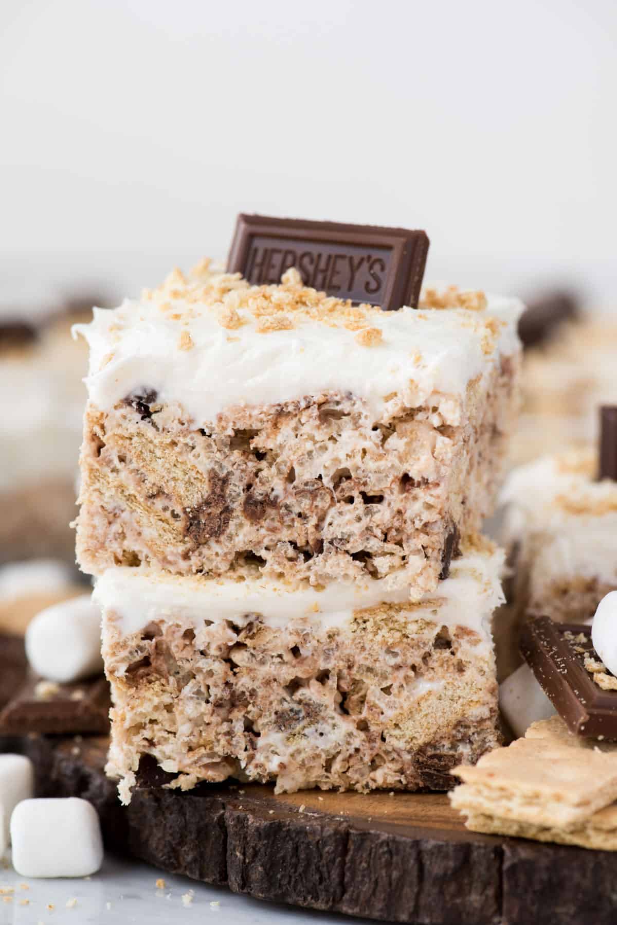 Two s’mores rice krispie treats cut into squares and stacked on top of each other