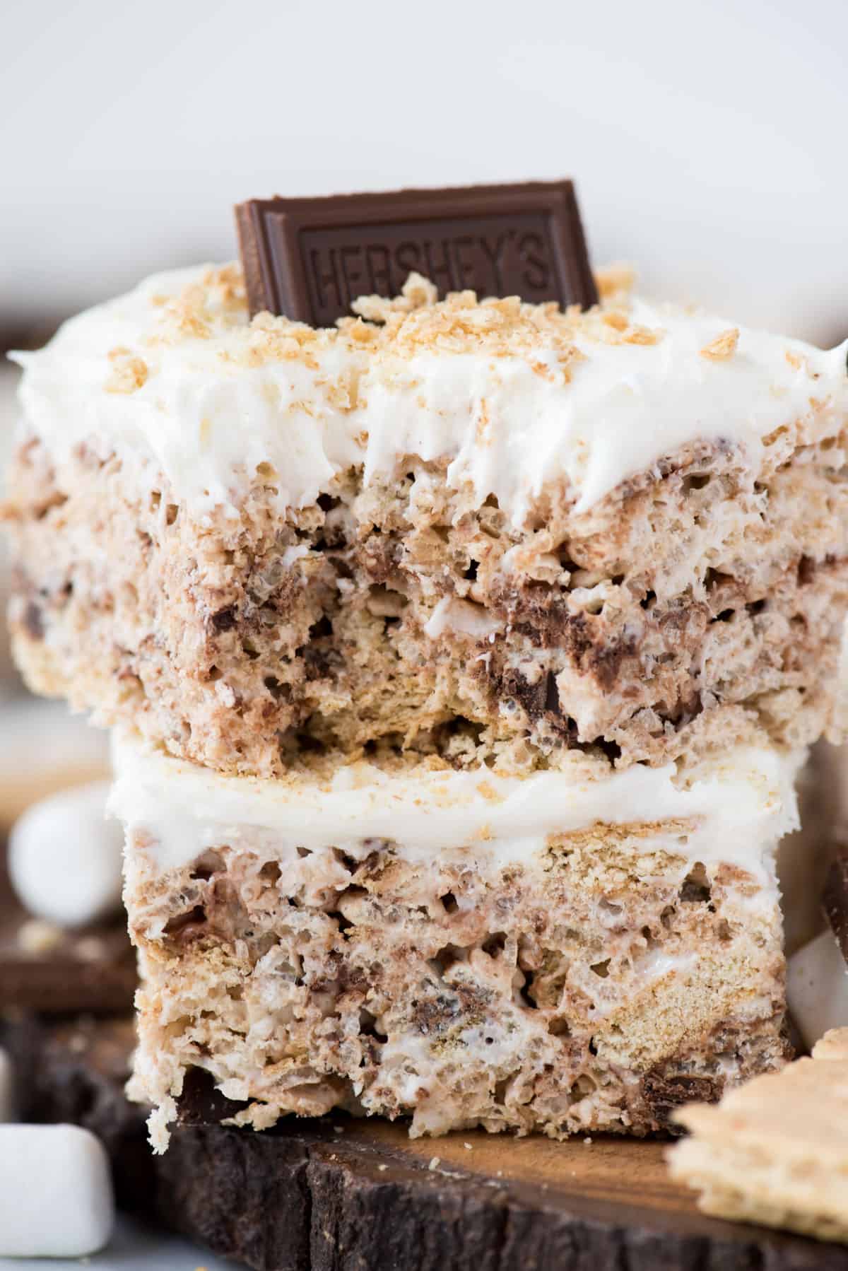 Two s’mores rice krispie treats cut into squares and stacked on top of each other close up