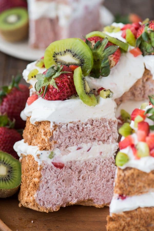 slice of strawberry angel for cake with whipped cream, strawberries and kiwi