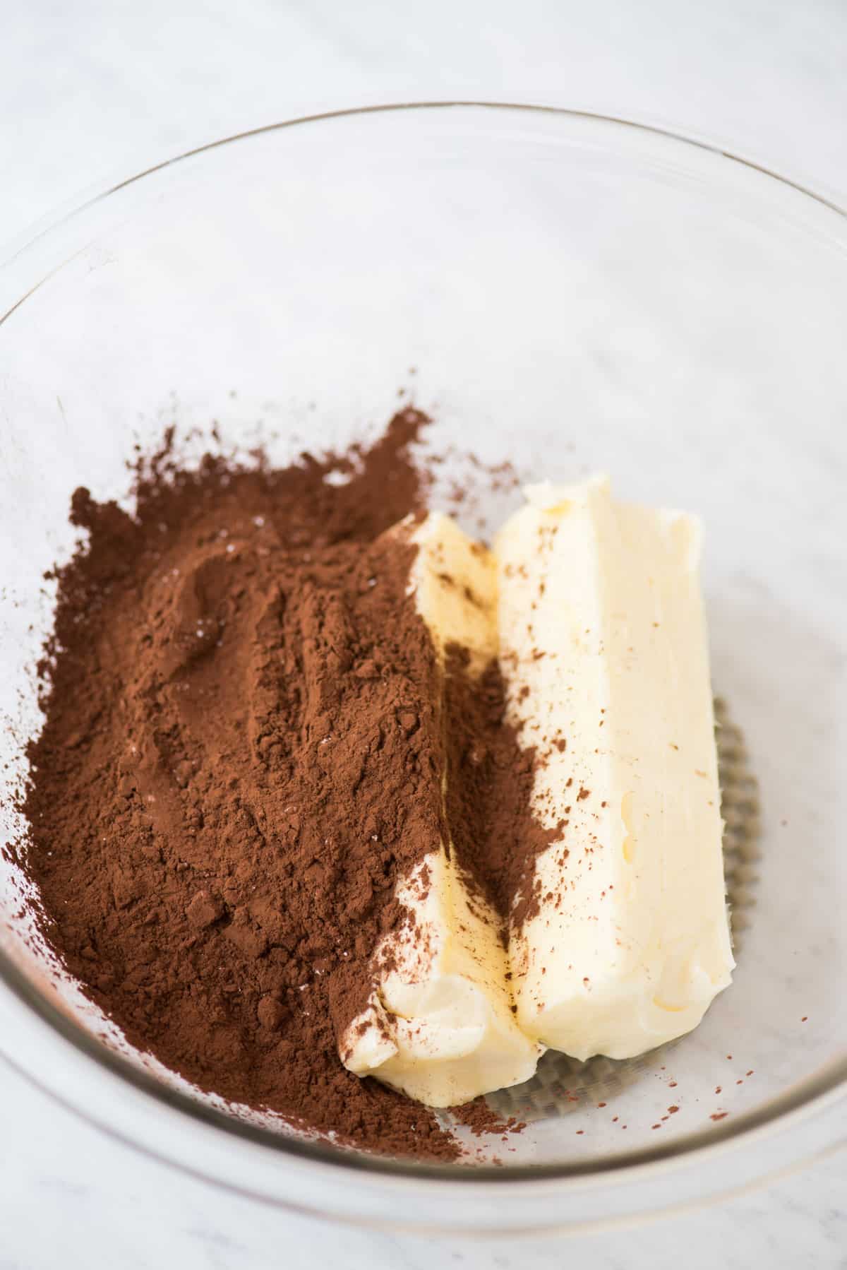 cocoa powder and butter in glass bowl