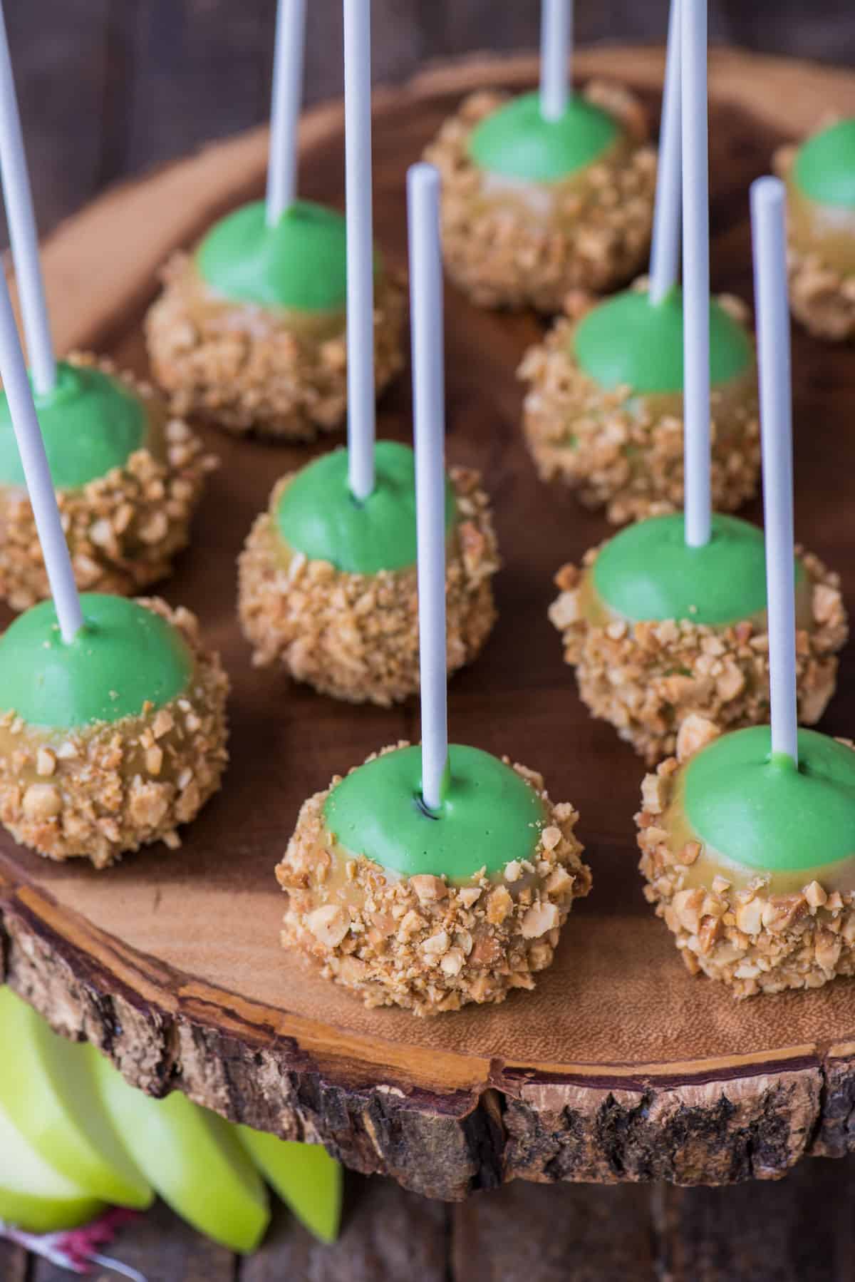 oreo balls that look like caramel apples on round wooden stand 