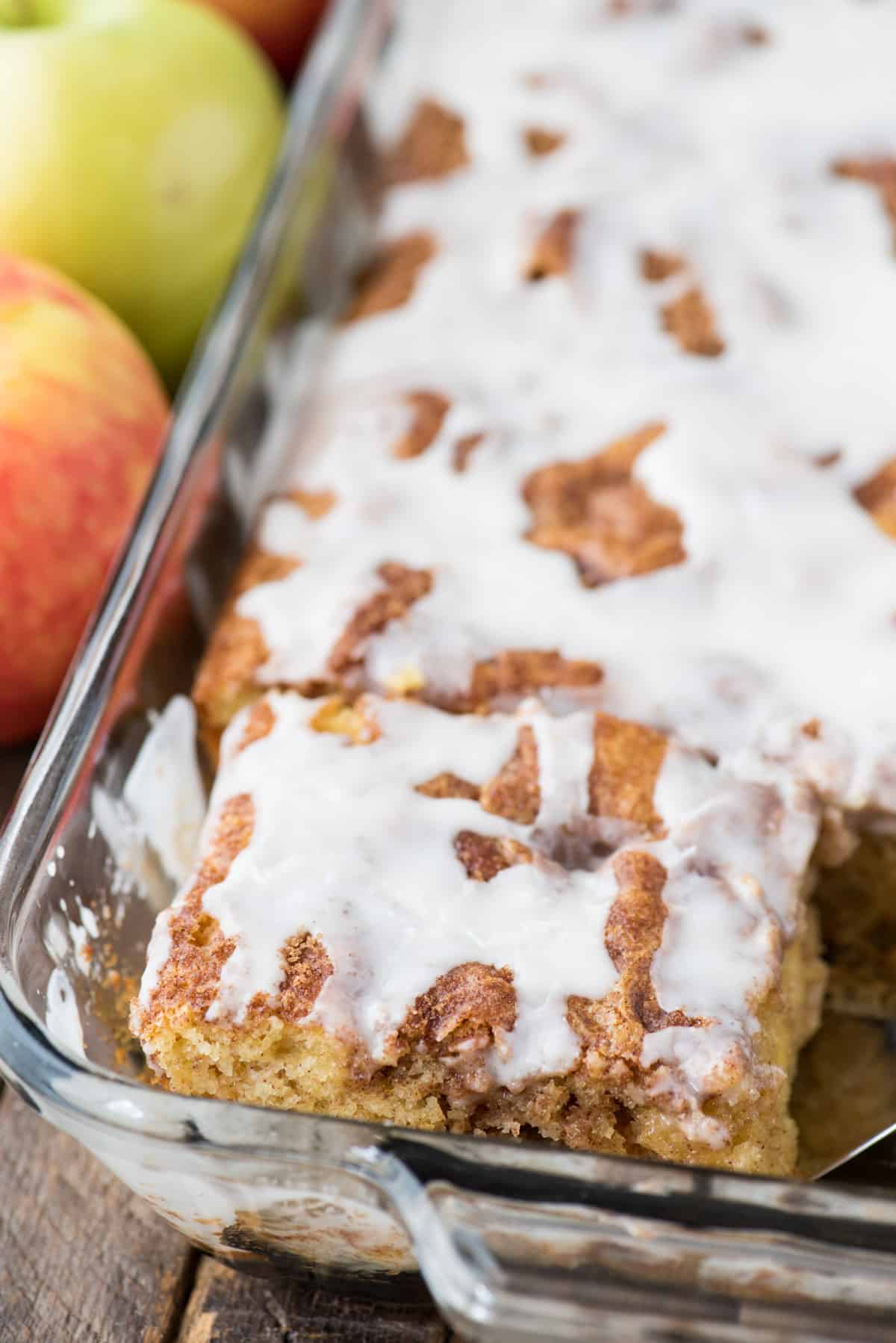 apple coffee cake with white icing in glass 9x13 inch pan