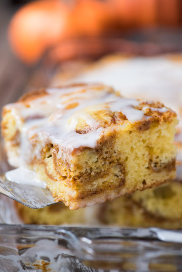 a slice of yellow cake swirled with a pumpkin layer on metal spatula