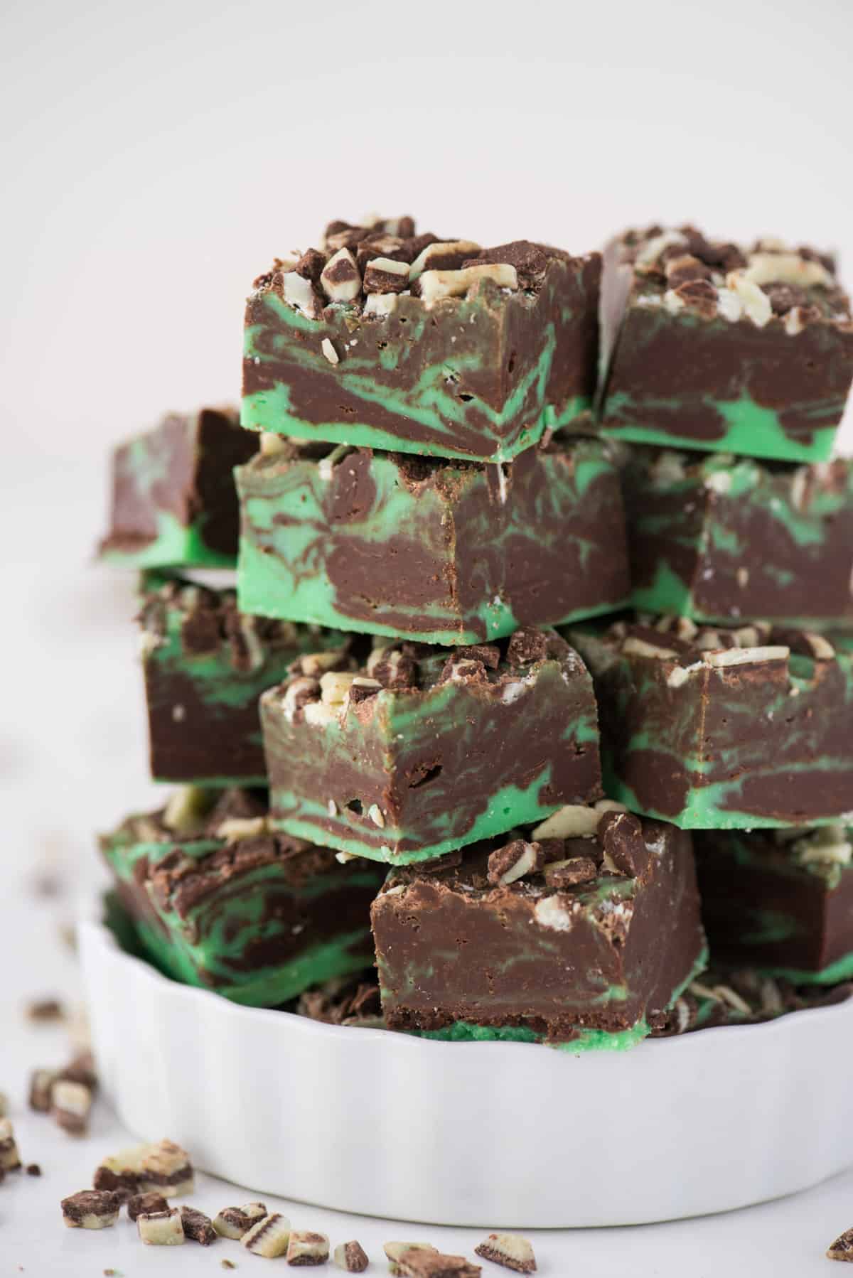 mint chocolate fudge pieces stacked in a white bowl