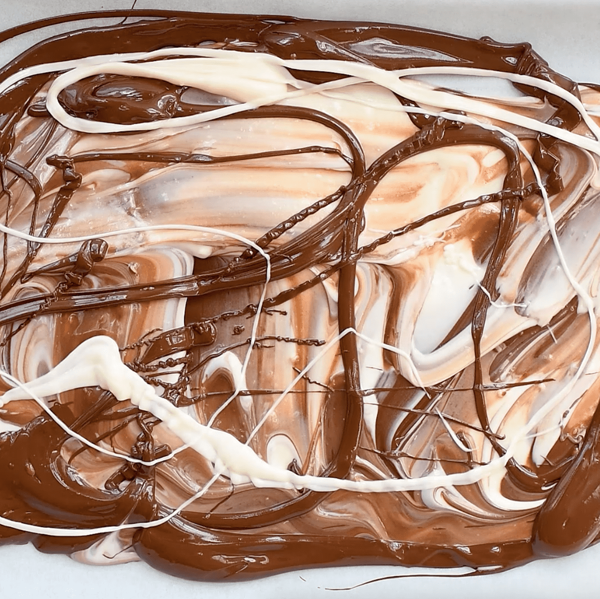 swirling chocolate and white chocolate together to make peppermint bark