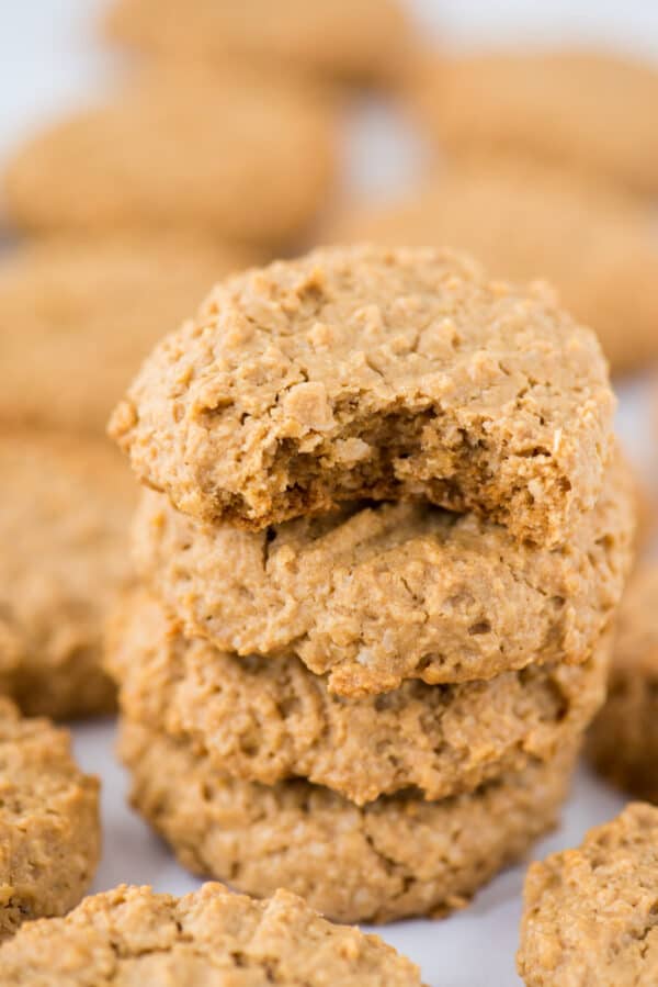 healthy peanut butter cookies in a stack on white background