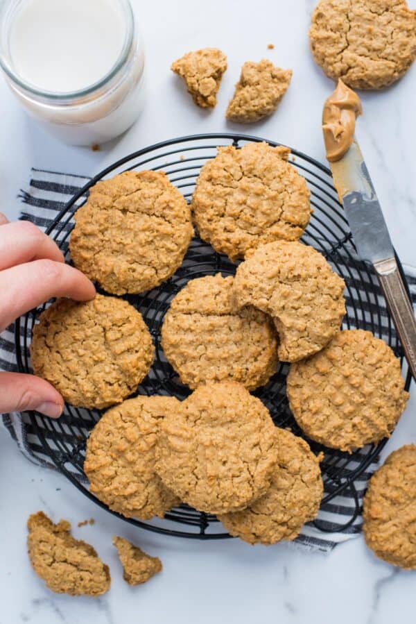 healthy peanut butter cookies on a black wire cooling rack on white background