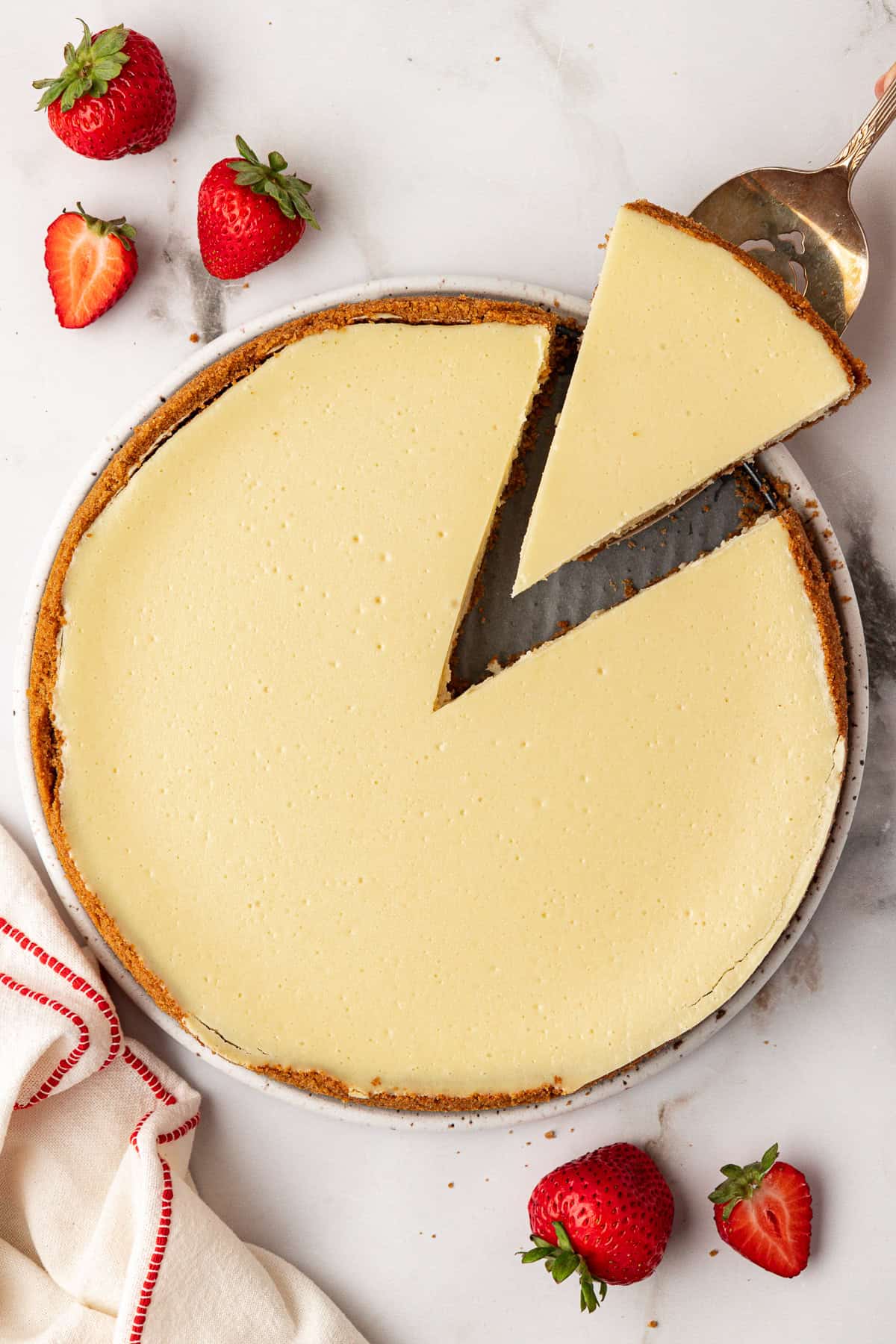 single slice of cheesecake removed from cheesecake