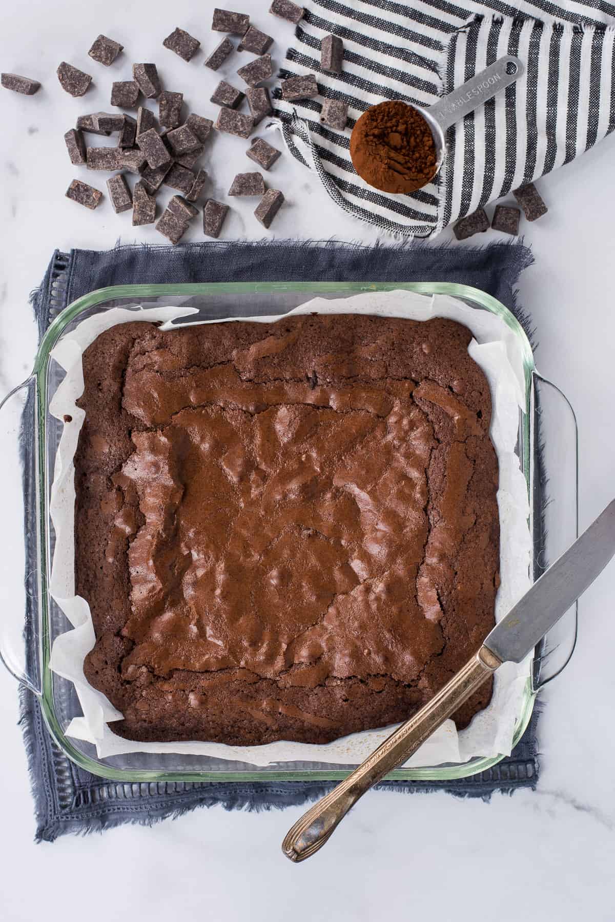 brownies in glass pan on white background