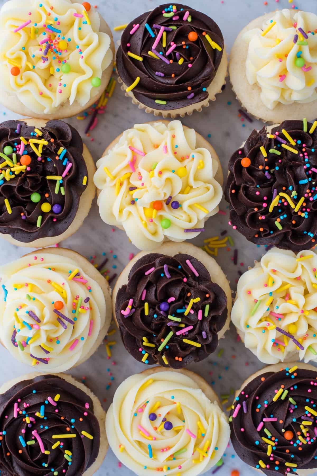 easy white cupcakes with chocolate or vanilla frosting with colorful sprinkles