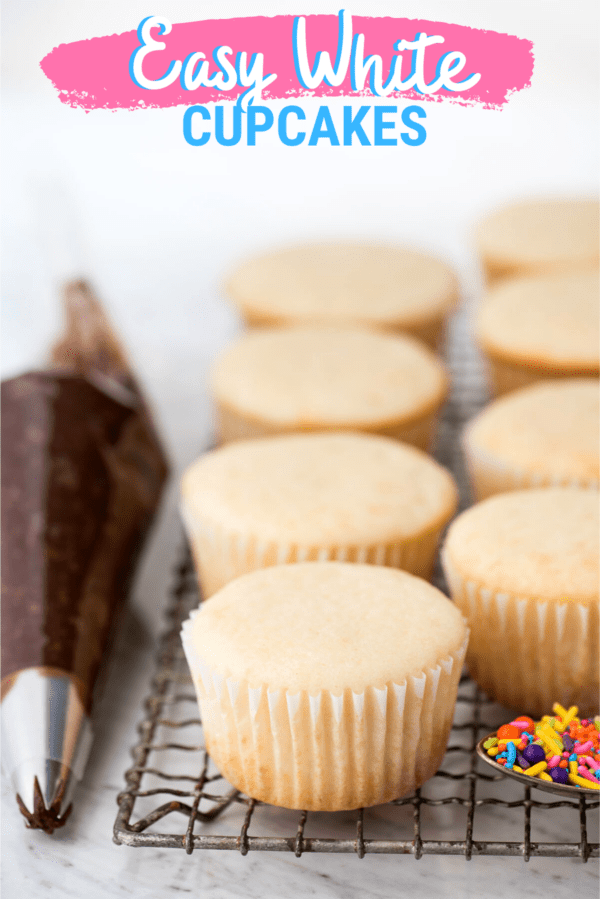 unfrosted white cupcakes on wire cooling rack