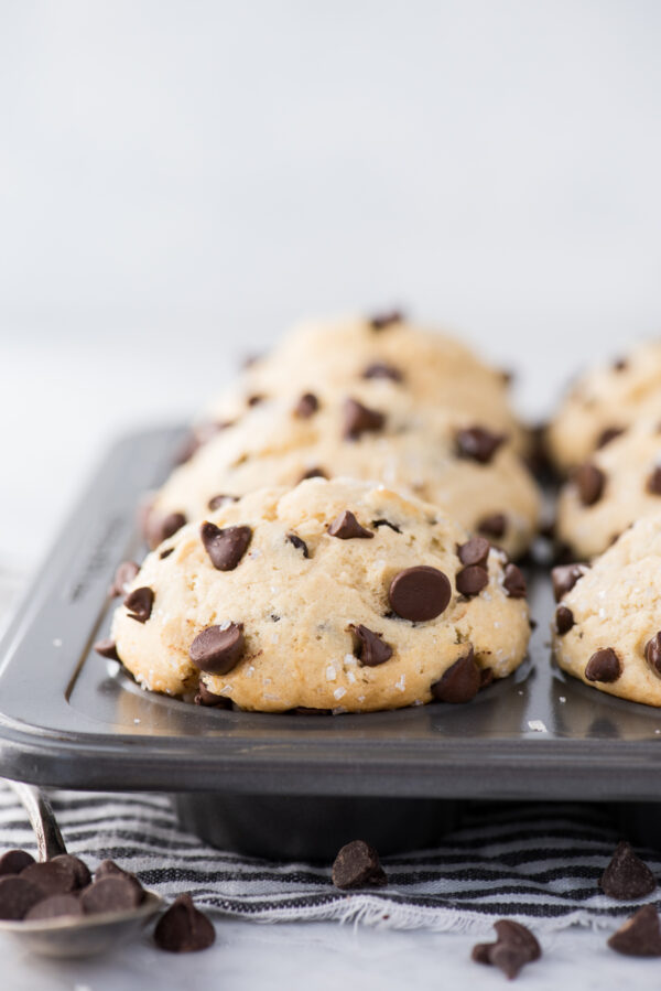 chocolate chip muffins with domed muffin tops in metal muffin pan
