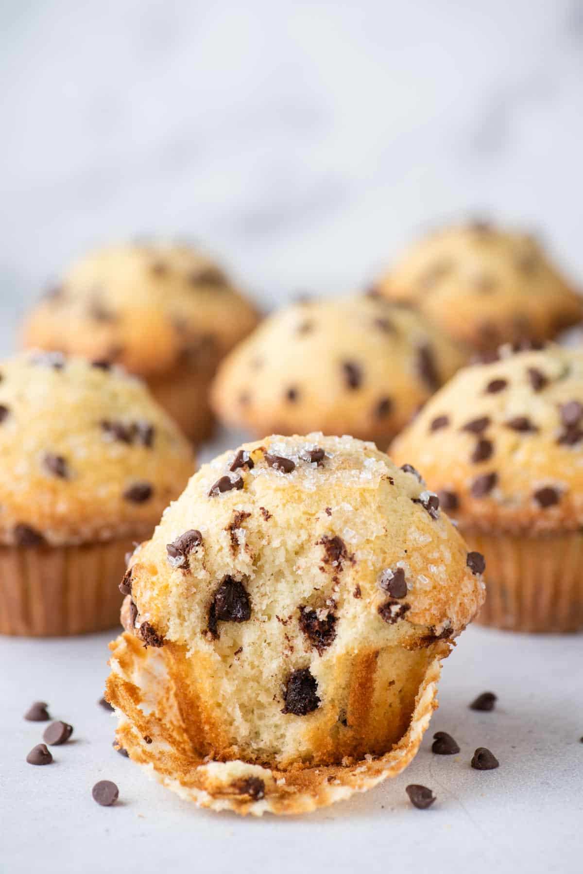 chocolate chip muffins arranged on white background
