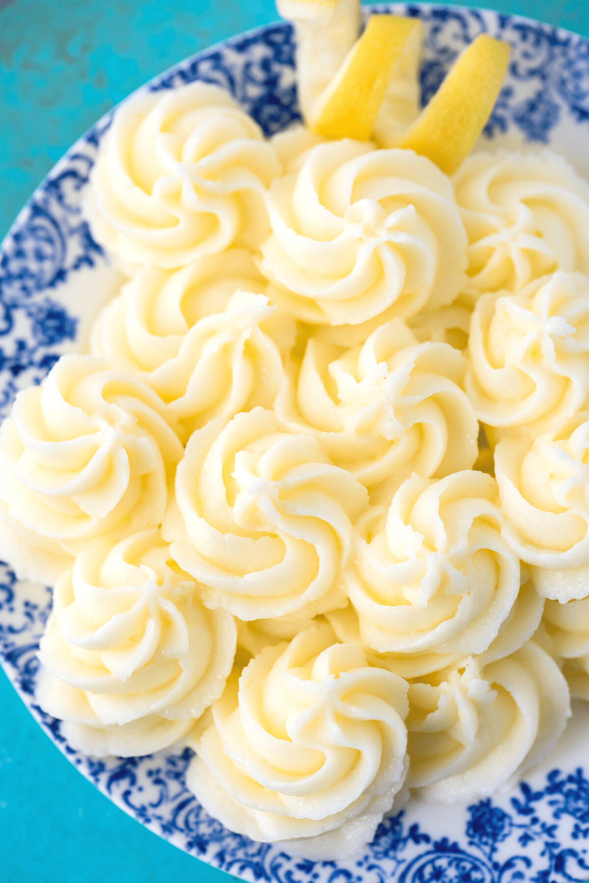 lemon frosting swirled piped onto blue floral plate