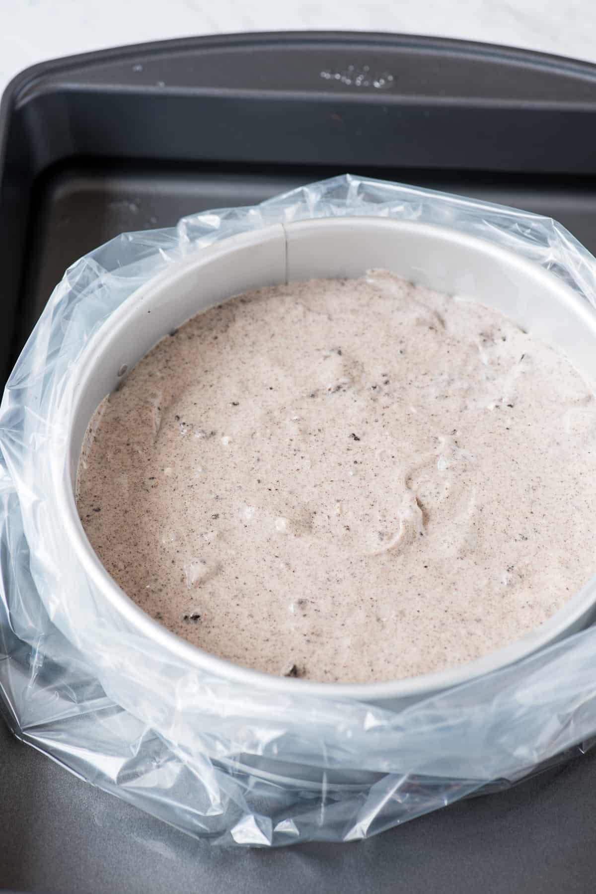 oreo cheesecake batter in springform pan inside water bath