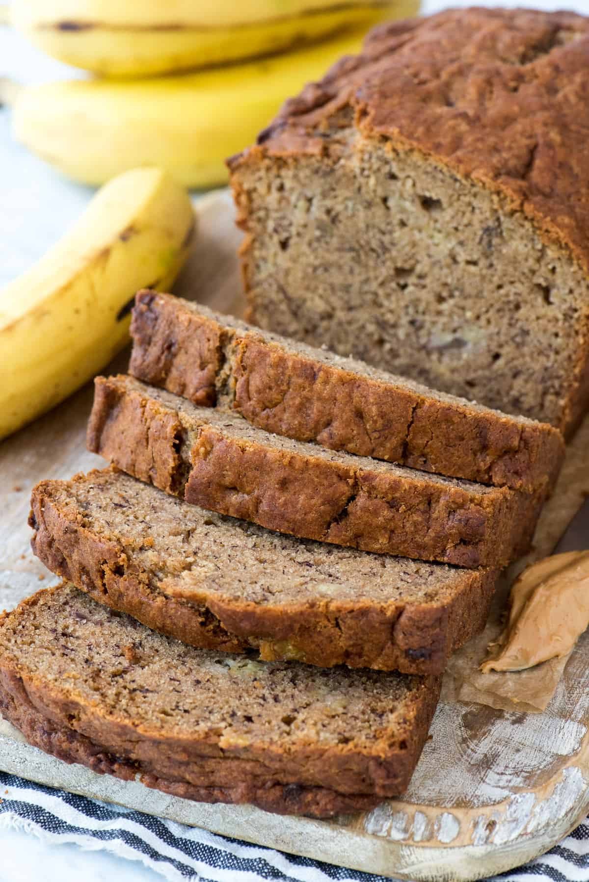 peanut butter banana bread slices on wood cutting board