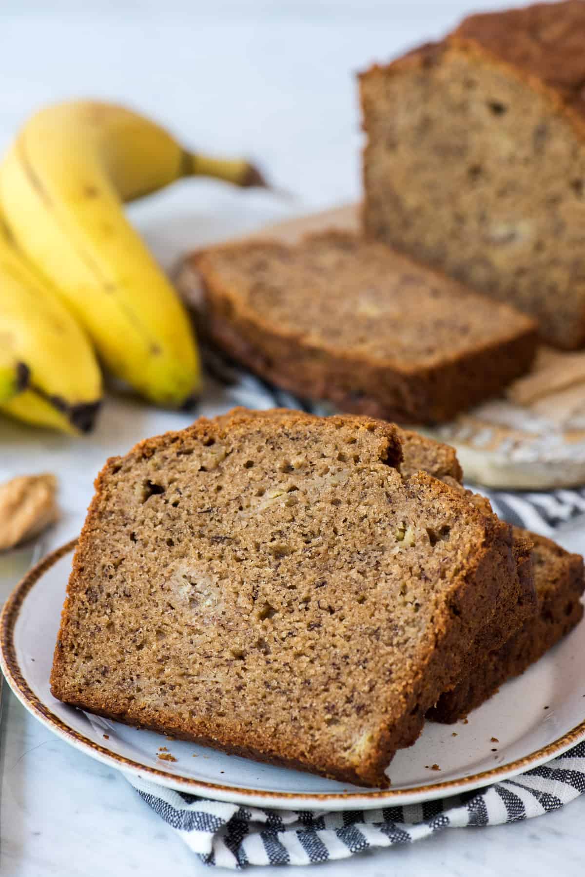 peanut butter banana bread on white plate with striped blue napkin