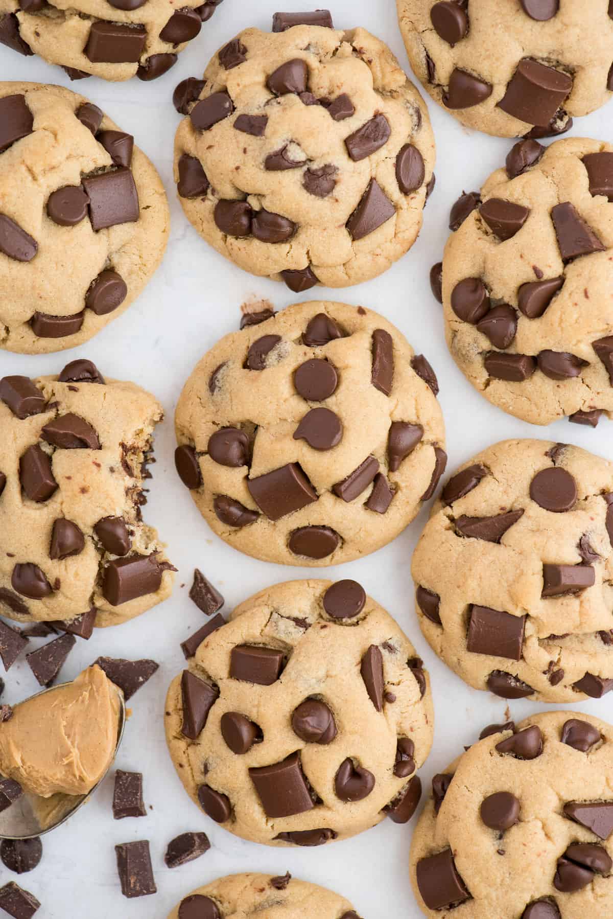 peanut butter chocolate chip cookies in a line on white background
