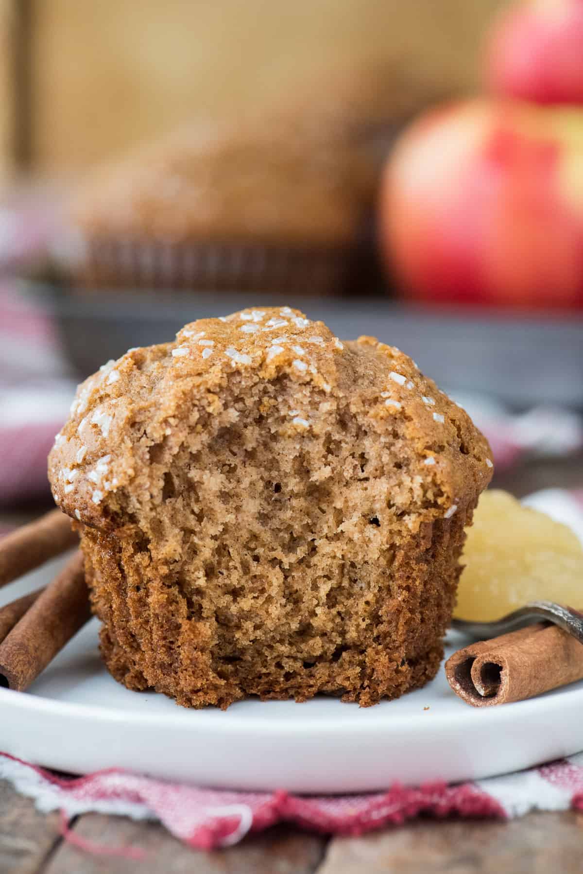 apple muffin with bite removed on white plate