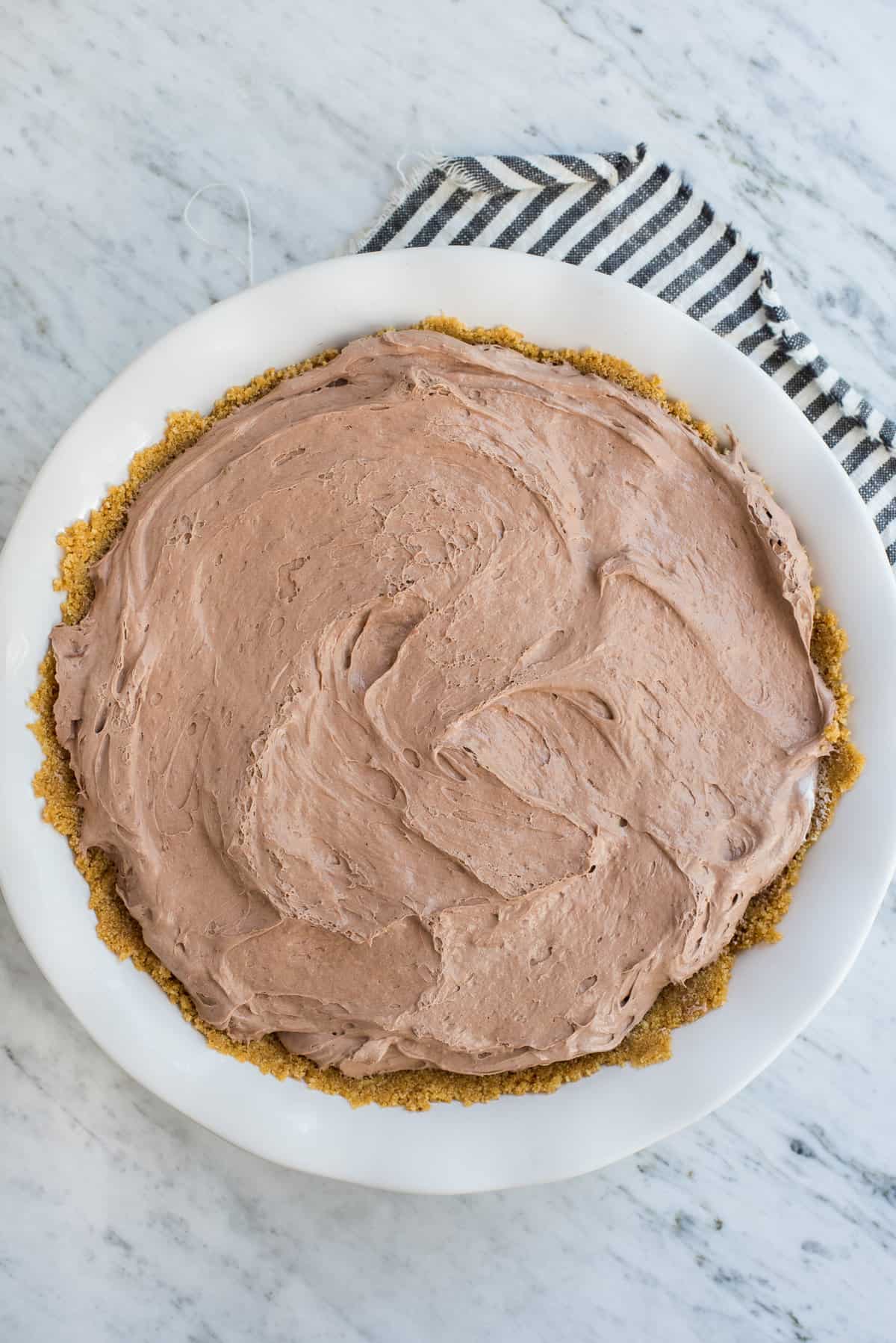 chocolate pudding pie in pie plate with graham cracker crust