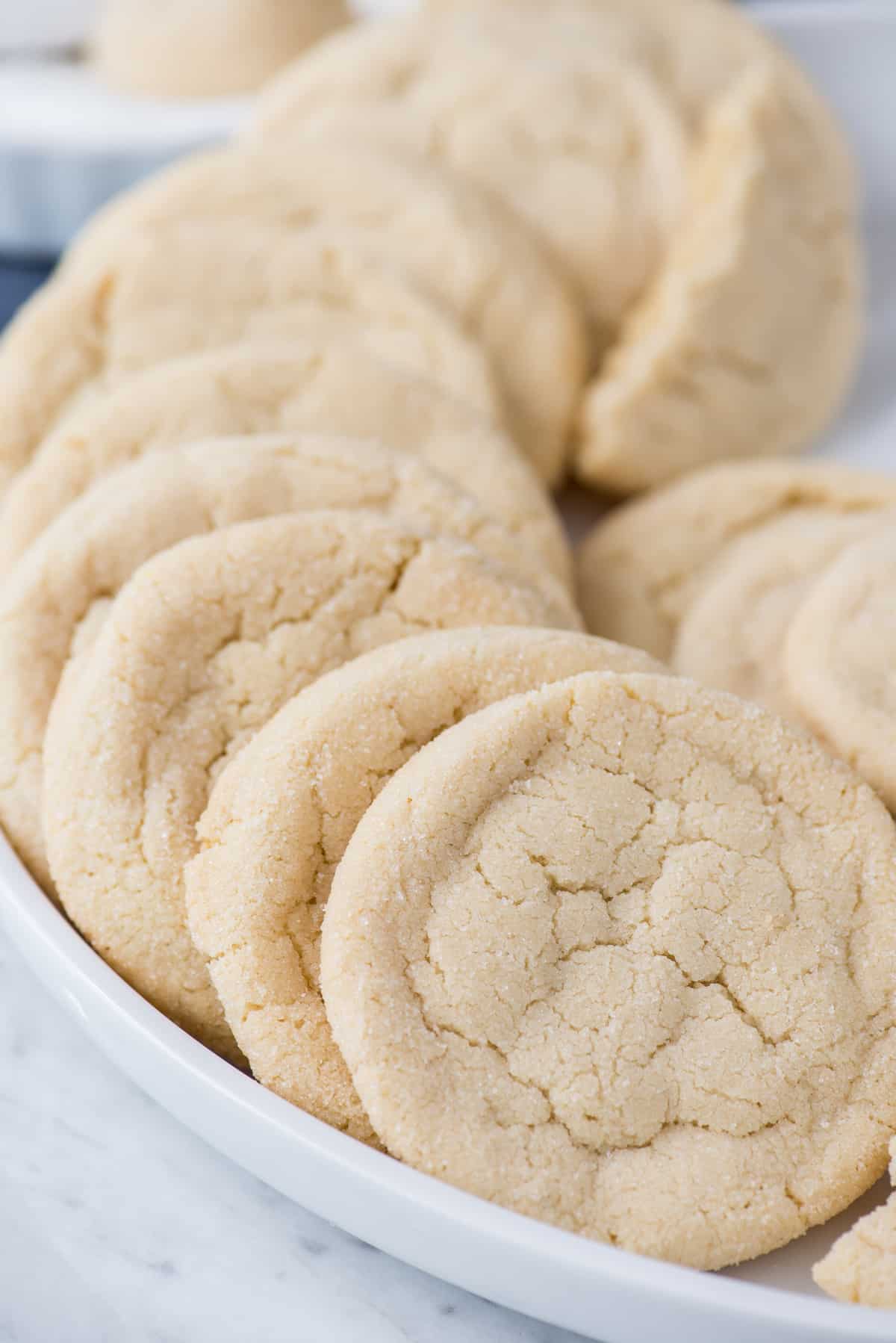 amish sugar cookies lined up in a curve on white platter