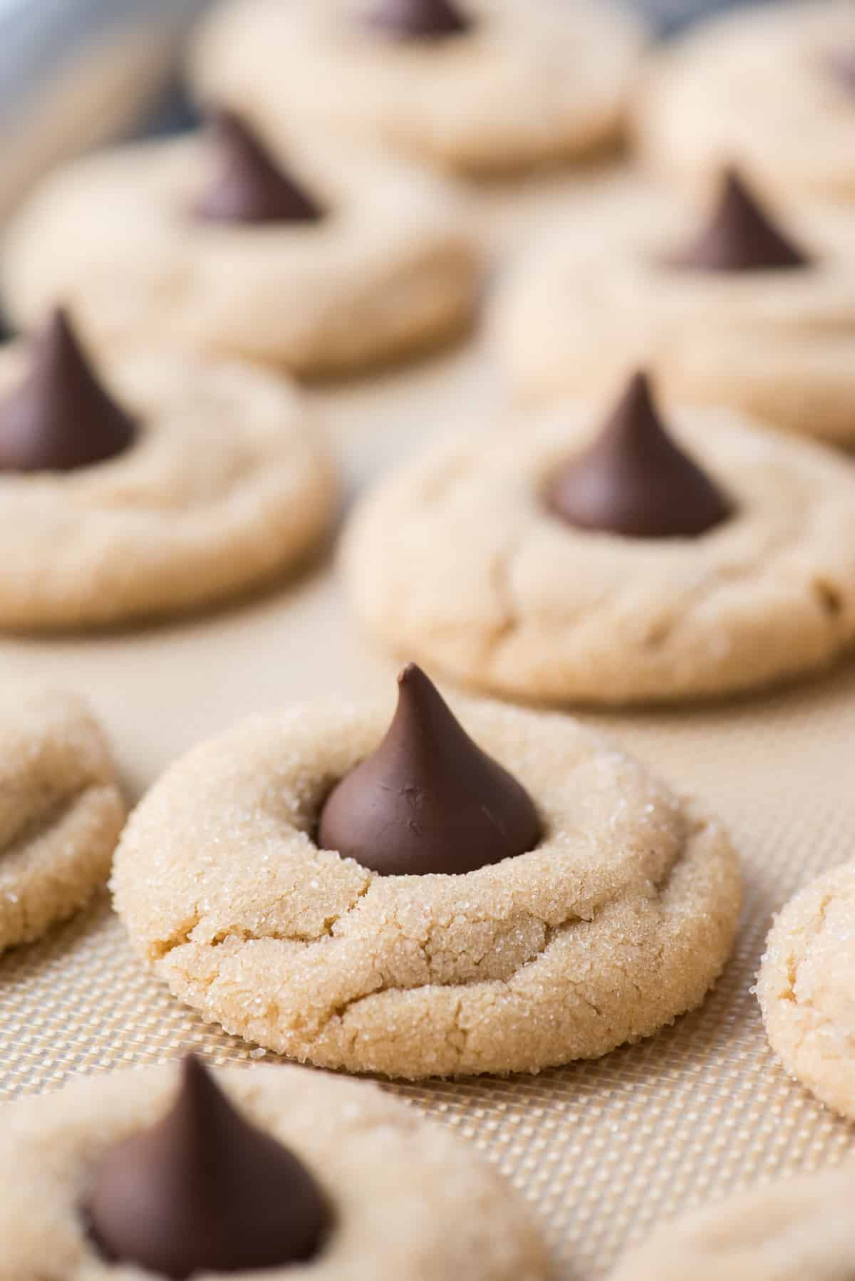 peanut butter blossom cookies on silicone baking mat