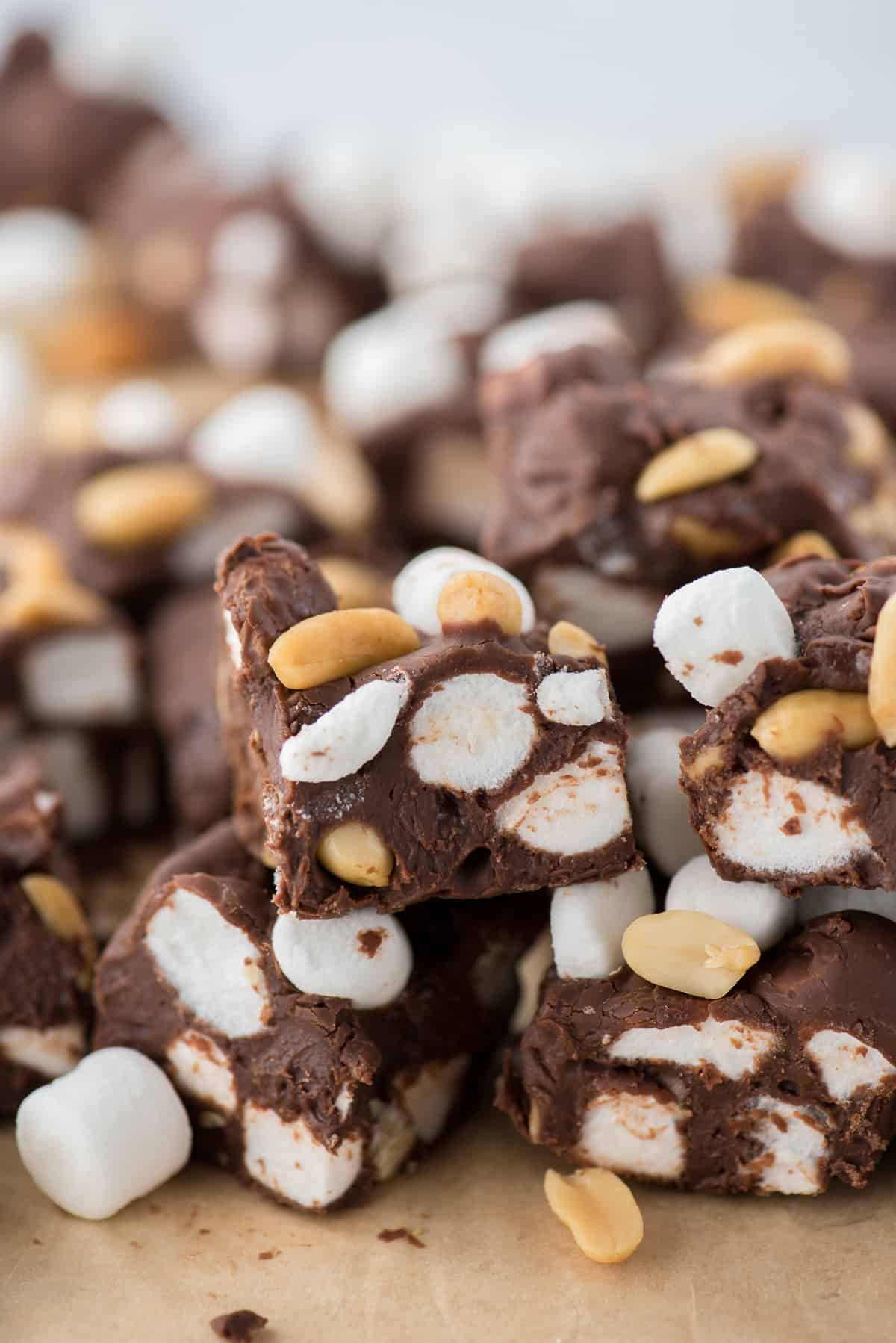 rocky road fudge cut into squares and arranged in a pile on brown parchment paper