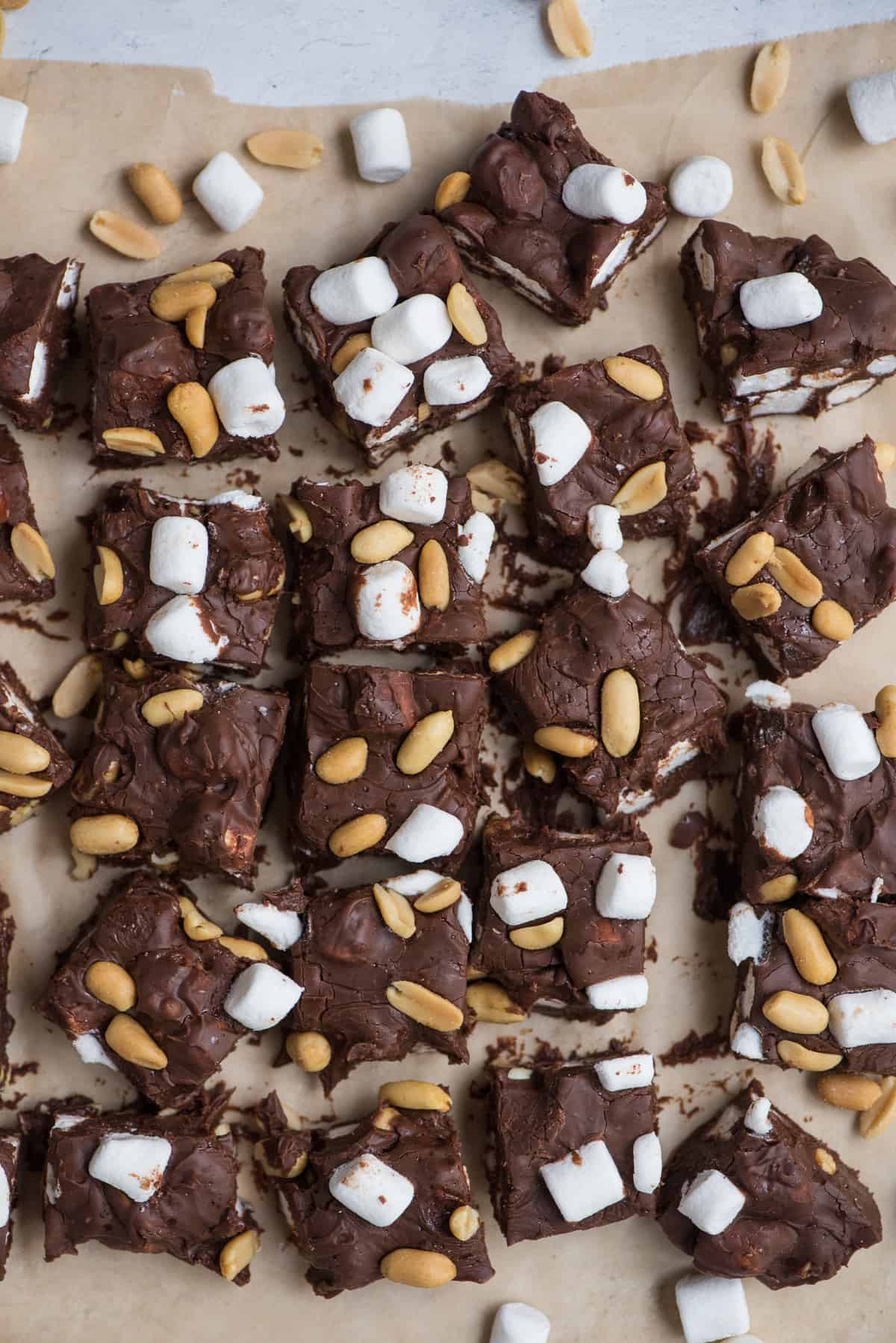 rocky road fudge cut into squares and arranged on brown parchment paper