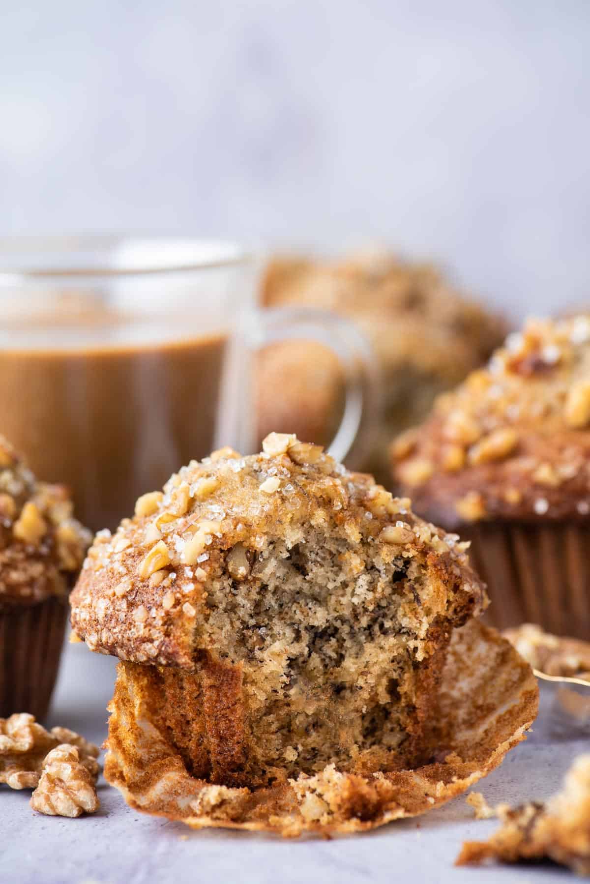 banana nut muffin with bite removed on purple background