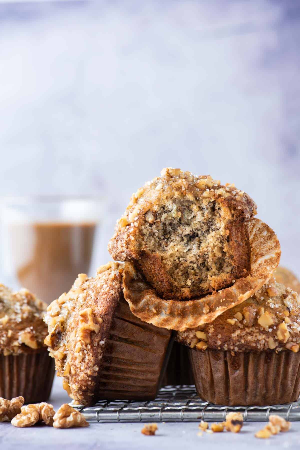 banana nut muffins stacked in a pile on wire rack